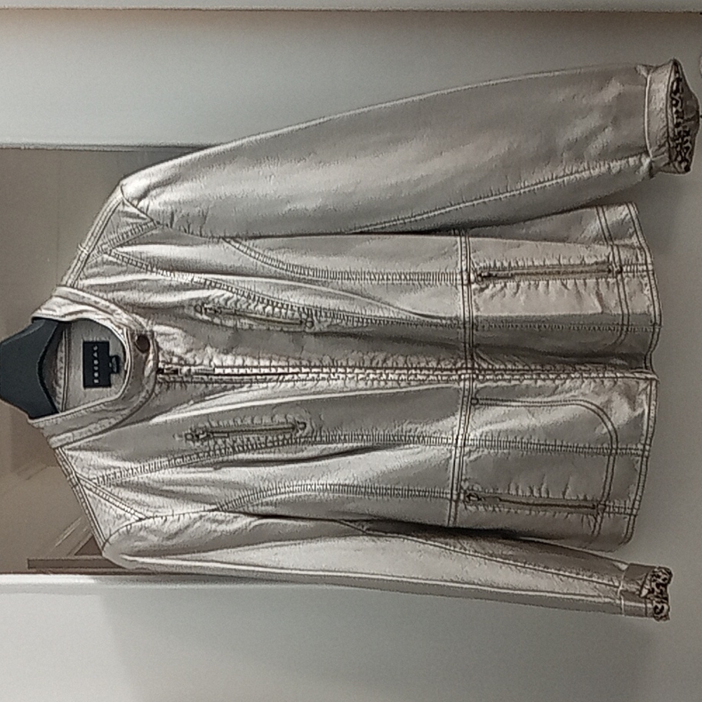Tribal silver jacket with leopard lining. Multiple zippers on jacket. Size 12